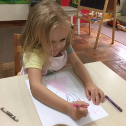 Phoebe draws a picture of mum.