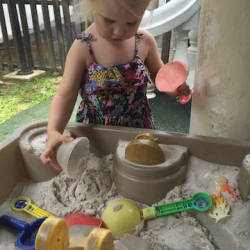 Penelope enjoying sand play.