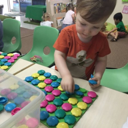 August working on his fine motor and colour recognition skills