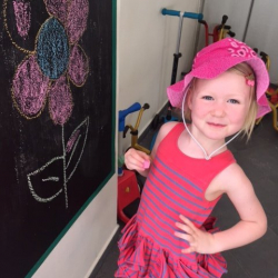 Ottilie enjoys drawing with chalk.