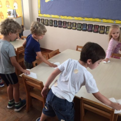 Some of the children cleaning the table before snack.