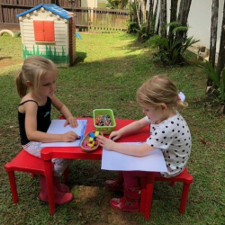 Phoebe & Sophie drawing in the garden.