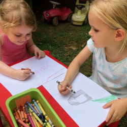 Sophie & Phoebe chat whilst coloring outside.