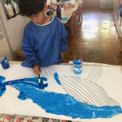 Maxwell painting his humpback whale.