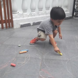 Isaac getting creative with chalk play!