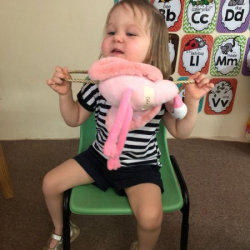 Coco all excited about her pink flamingo bag for show and tell!
