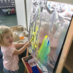 Martha exploring colour mixing on tin foil!