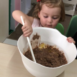 Rose helping to mix our muffin ingredients together!