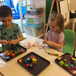 Enzo and Matilda did a great job lacing the beads on a string!