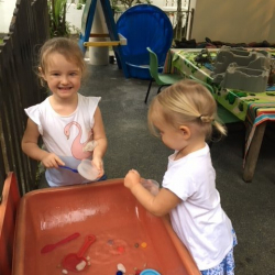 Matilda and Ella worked on scooping in the water table.
