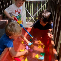 August, Eddie, and Ravi had fun fishing in the water table.
