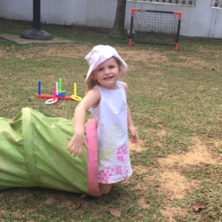Claudia enjoyed the fun tube during outside play.