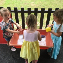 Matilda, Claudia, and Bella enjoyed the scrubbing bubbles in the water table!