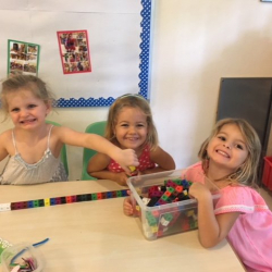 Claudia, Bella, and Katie made a long cube train together.