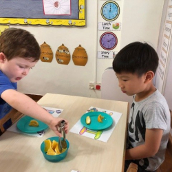 August was the special helper, he was helping to serve the fruit.
