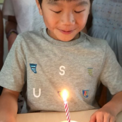 Isaac making a wish before blowing out his candle.