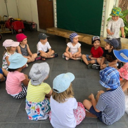 Playing 'Duck Duck Goose' during outdoor play.