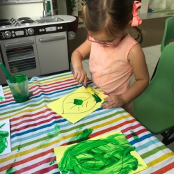 Annabel helping to paint leaves for our tree