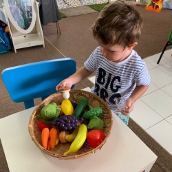 George exploring fruits and vegetables!