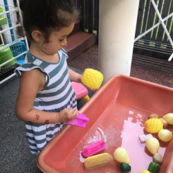 Laila scrubbed some letter P items in the water table.