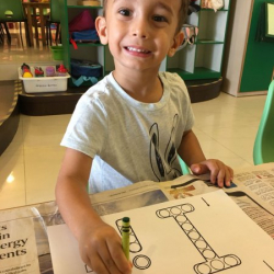 Lorenzo worked on his I paper with dot stampers and crayons.