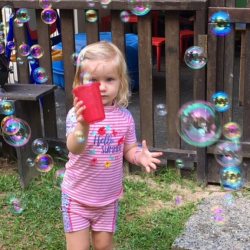 Martha tried hard to catch bubbles in the cup!