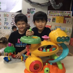 Noah and Samuel explored a cool toy in the Butterflies class.