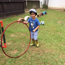 Noah had fun rolling the big hoop in the yard.