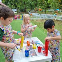 Logan , Regan and Lorenzo working hard to complete their rocket .
