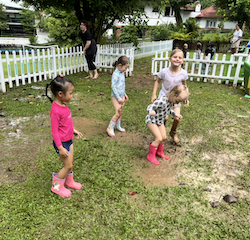 The girls enjoying the muddy puddle.