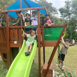 Travor, Xiao Yan and Lorenzo experimenting with the slides and the cars