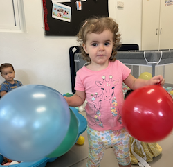 Deni enjoying playing with the balloons!