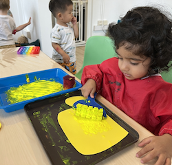 Nila roller painting her yellow bus!