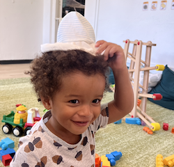 Teddy trying on the babies hat!