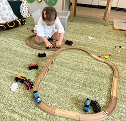 Victoire enjoying the train track we built!