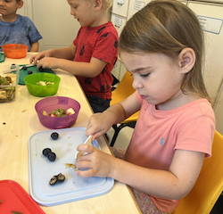 Mia making a delicious fruit salad bowl