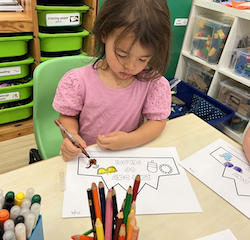 Myla colouring her paper crown