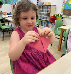 Paige learning to fold a paper boat!