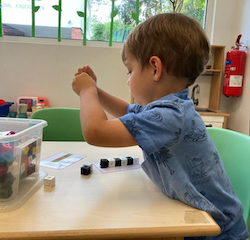 Spencer enjoying a counting and patterning game