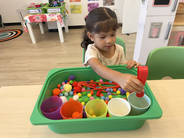 Alara practising her fine motor skills and colour sorting.