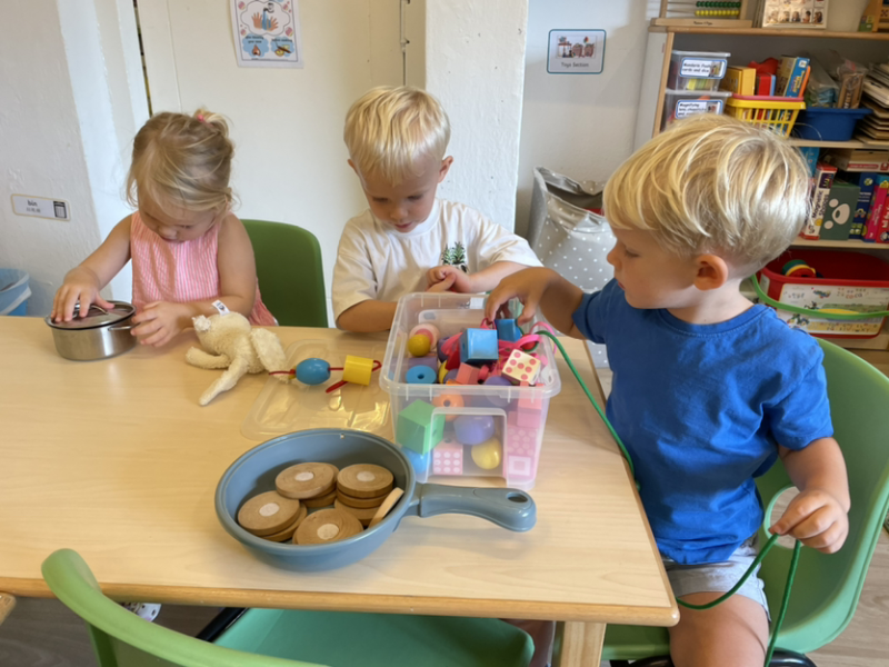 Alex, George and Henry playing with the wooden beads.