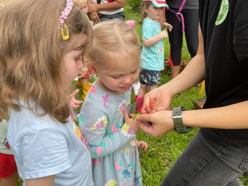 Alex and Clemmie seeing the “lipstick plant.”