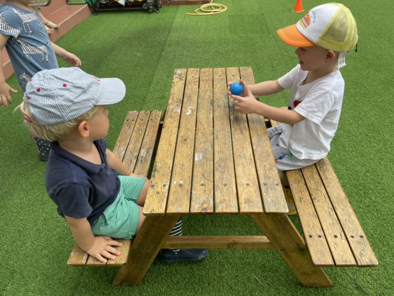 George and Henry talking together during outside play.