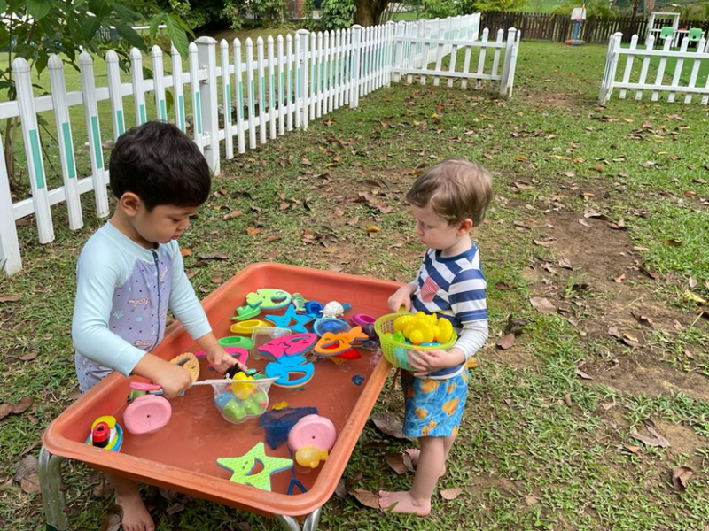 George and Isaac playing at the water table..png