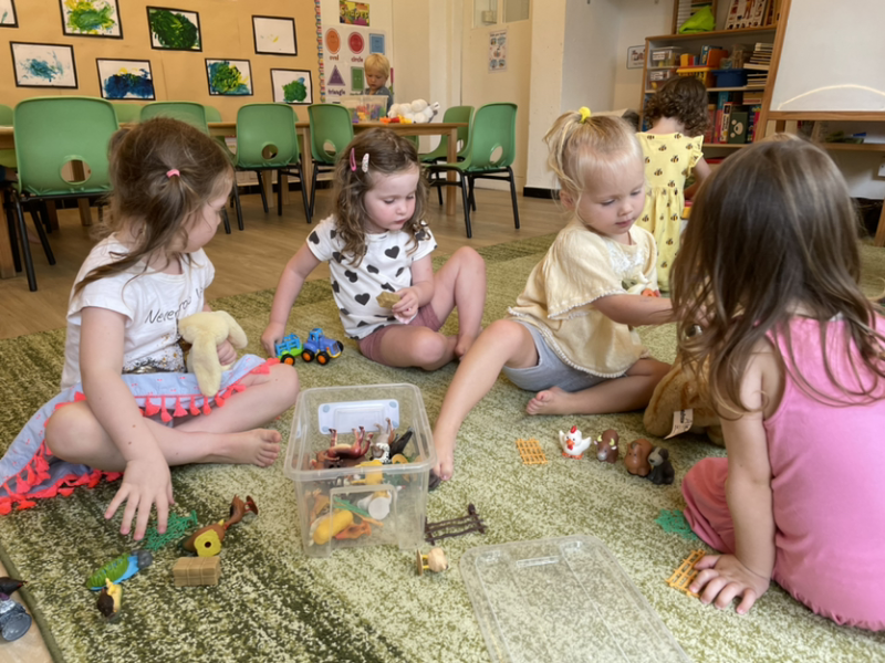 Lulu, Clemmie, Mia and Alex working together to set up the farm animals.