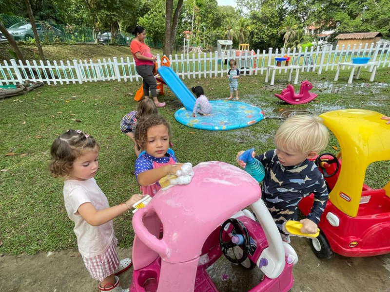 Mia, Lydia and George washing the car.