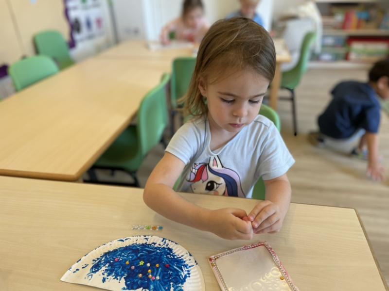 Mia decorating her diya.