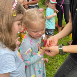 Alex and Clemmie seeing the “lipstick plant.”