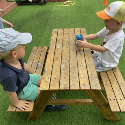 George and Henry talking together during outside play.