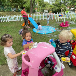 Mia, Lydia and George washing the car.